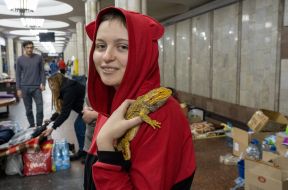 A girl with an iguana at one of the subway stations