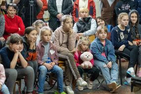 Children watch a puppet show at one of the subway stations