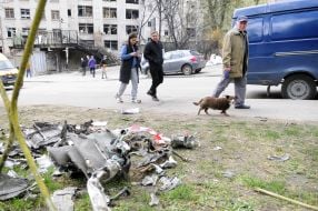 People walk past fragments of the Kalibr cruise missile