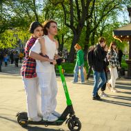 Young couple riding electric scooter