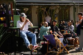 Young people are resting on the summer playground of the cafe