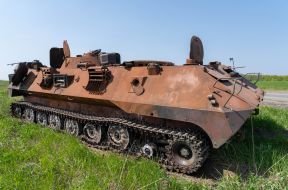 Tracked armored personnel carrier of the Russian invaders on the field in Kharkiv region