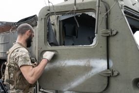 Ukrainian soldier inspects damaged Russian military equipment