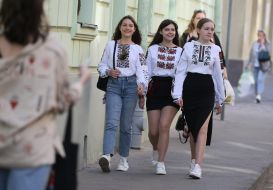 Passers-by in embroidered shirts on the street in Lviv
