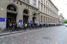 People are standing in line near the Main Post Office of Lviv