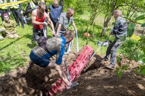 Volunteers take home from the grave during the exhumation of the body of a murdered resident of the village of Koropove