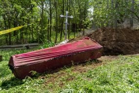 Coffin during the exhumation of the body of a murdered resident of the village of Koropove