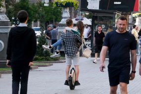 The guy on a unicycle with a girl in his arms