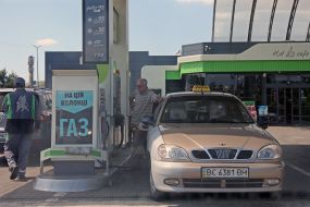Refueling a car with gasoline at a gas station