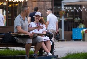 A man with a kobza sits on a bench in the center of Kiev