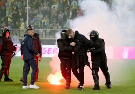 Law enforcement officers remove the violator from the field