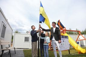 The ceremony of raising the flag of Ukraine in a modular town for migrants