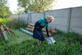 A local woman shows a rocket that flew into the house during the shelling of Russian occupiers