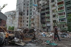 Burned car near the destroyed houses