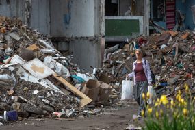 A woman near the destroyed houses in Chernihiv