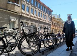 A Muslim woman walks by the bicycle
