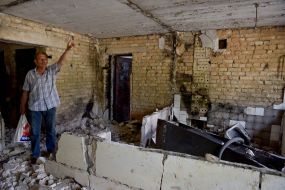 A man inspects a house in Irpen destroyed by shelling by Russian occupiers