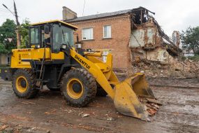 Clearing rubble from destroyed buildings