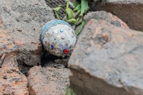 Easter egg (pysanka) in the ruins of a destroyed house