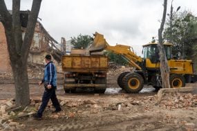 Clearing rubble from destroyed buildings