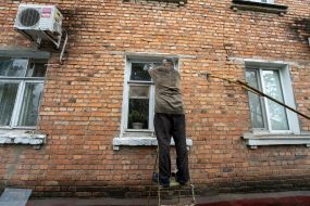 man fixing windows