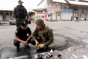 Experts inspect fragments of a MLRS shell