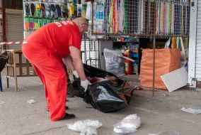 An ambulance doctor puts the body of a murdered man in a black bag in Kharkiv