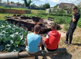 Cabbage around the destroyed tank of the Russian invaders in the vegetable garden in the village of Velyka Dymerka