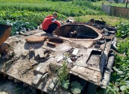 Cabbage around the destroyed tank of the Russian invaders in the vegetable garden in the village of Velyka Dymerka