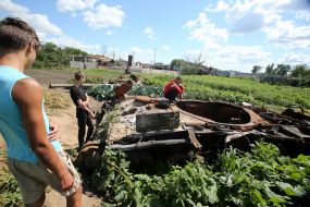 Cabbage around the destroyed tank of the Russian invaders in the vegetable garden in the village of Velyka Dymerka