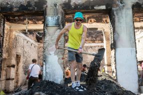 Volunteers clean up the rubble of the House of Culture in the village of Yagidne, Chernihiv region