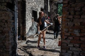Volunteers clean up the rubble of the House of Culture in the village of Yagidne, Chernihiv region