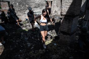 Volunteers clean up the rubble of the House of Culture in the village of Yagidne, Chernihiv region
