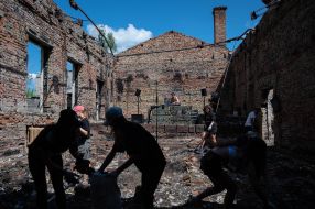 Volunteers clean up the rubble of the House of Culture in the village of Yagidne, Chernihiv region