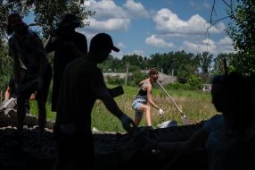 Volunteers clean up the rubble of the House of Culture in the village of Yagidne, Chernihiv region