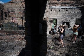 Volunteers clean up the rubble of the House of Culture in the village of Yagidne, Chernihiv region