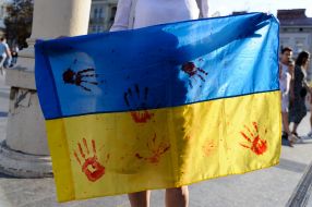 The flag of Ukraine in bloody handprints