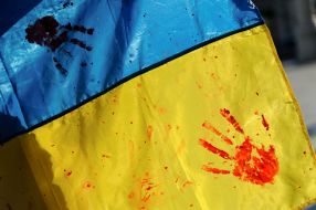 The flag of Ukraine in bloody handprints