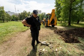 An employee of the National Police of Ukraine near the remnants of ammunition