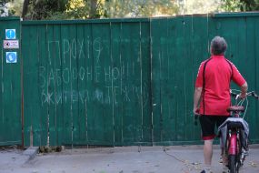 A fence near a house damaged by Russian missiles