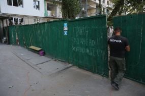 A fence near a house damaged by Russian missiles
