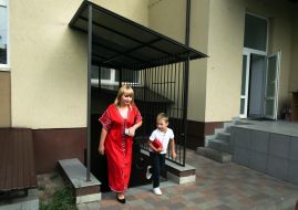 A teacher and a student leave the school bomb shelter in one of the schools in Bucha