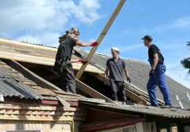 Volunteers of the Church of Christians participate in the restoration of a destroyed residential building in the city of Bucha