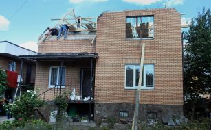 Volunteers of the Church of Christians participate in the restoration of a destroyed residential building in the city of Bucha