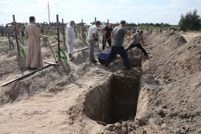 Burial of unidentified bodies of people who died and died during the occupation at the city cemetery in Bucha