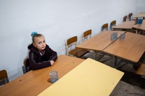 A schoolgirl behind the gate in a shelter during an air raid in the secondary school of the village of Mykhailivka-Rubezhivka near Irpen