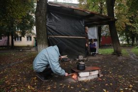 Due to the lack of gas and electricity supply, residents cook food in the yard on a fire in the village. Chkalov