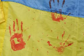 Bloody palm print on the flag of Ukraine