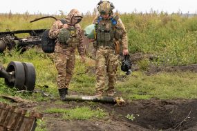Soldiers of the National Guard of Ukraine inspect weapons and remains of Russian armored vehicles