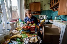Young woman reviewing humanitarian aid in her apartment